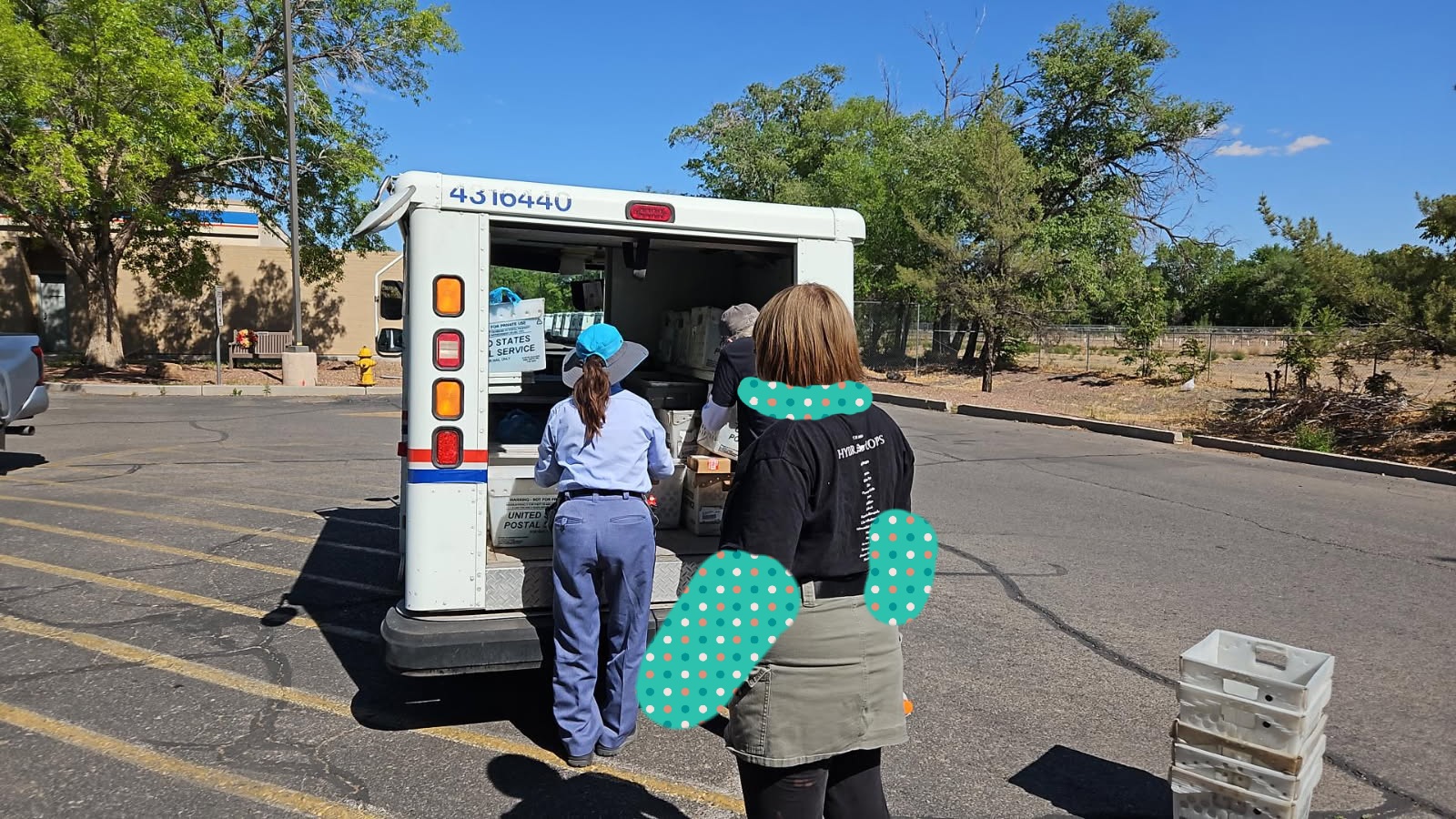 Mail carrier and volunteer food out of mail truck